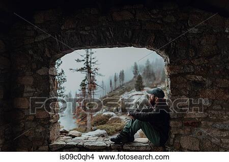 Hiker enjoying view of misty valley on ledge, Yosemite National Park, California, United States View Large Photo Image Picture - Hiker enjoying view of misty valley on ledge, Yosemite National Park, California, United States. Fotosearch