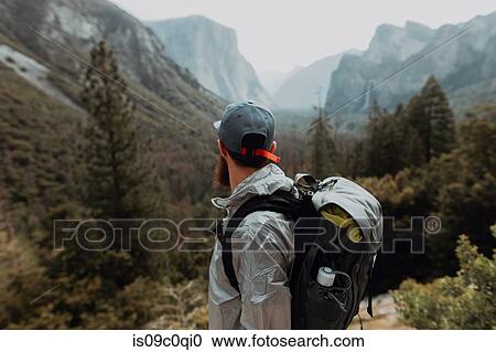Stock Image - Hiker exploring nature reserve, Yosemite National Park, California, United States. Fotosearch