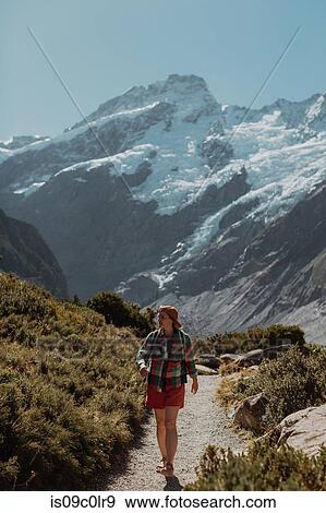 Stock Photo - Hiker exploring wilderness, Wanaka, Taranaki, New Zealand. Fotosearch