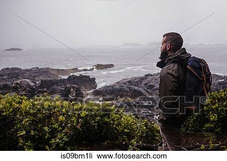 Hiker looking out to sea, Tofino, Canada View Large Photo Image Stock Image - Hiker looking out to sea, Tofino, Canada. Fotosearch