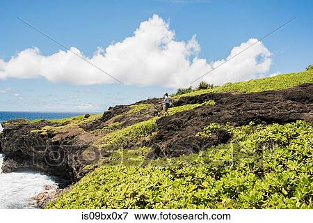 Stock Photo - Hiker on coast, Waipipi Trail, Maui, Hawaii. Fotosearch