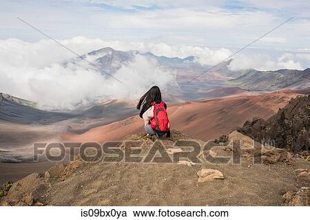 Hiker on edge of mountain top, Haleakala National Park, Maui, Hawaii View Large Photo Image Stock Image - Hiker on edge of mountain top, Haleakala National Park, Maui, Hawaii. Fotosearch