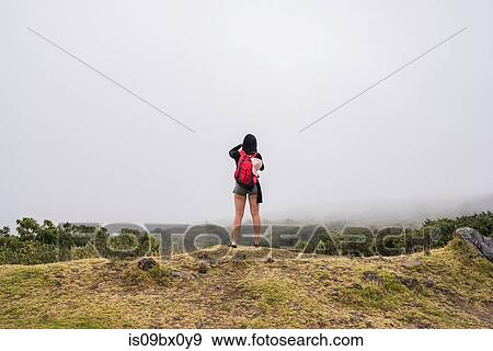 Stock Photo - Hiker on edge of mountain top, Haleakala National Park, Maui, Hawaii. Fotosearch