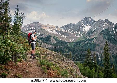 Picture - Hiker on mountain peak, Mount Sneffels, Ouray, Colorado, USA. Fotosearch