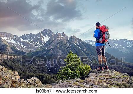 Stock Image - Hiker on mountain peak, Mount Sneffels, Ouray, Colorado, USA. Fotosearch
