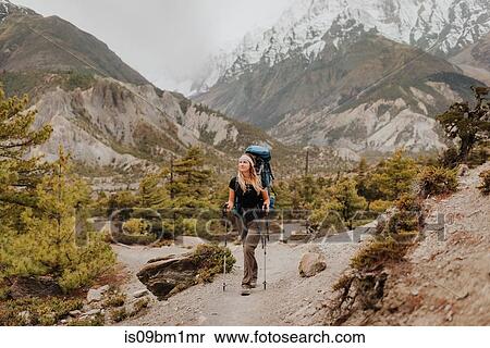 Stock Photography - Hiker on trail, Annapurna Circuit, the Himalayas, Manang, Nepal. Fotosearch