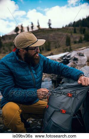 Hiker packing backpack, Mineral King, California, United States View Large Photo Image Stock Photograph - Hiker packing backpack, Mineral King, California, United States. Fotosearch