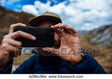 Hiker taking picture with phone, Mineral King, California, United States View Large Photo Image Stock Photo - Hiker taking picture with phone, Mineral King, California, United States. Fotosearch