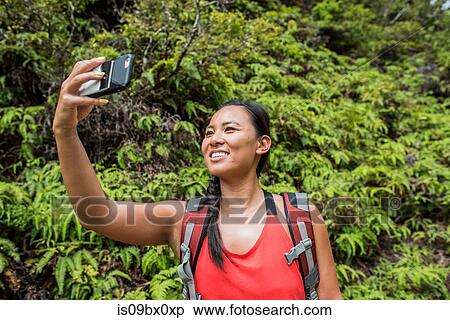 Hiker taking selfie in rainforest, Iao Valley, Maui, Hawaii View Large Photo Image Stock Photography - Hiker taking selfie in rainforest, Iao Valley, Maui, Hawaii. Fotosearch