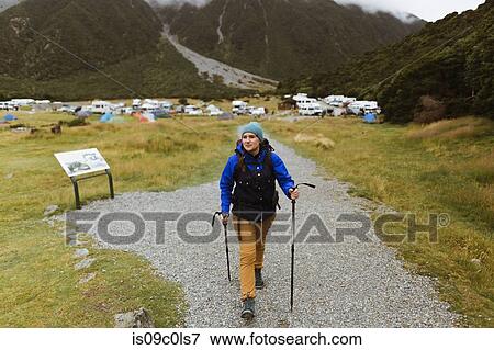 Stock Photo - Hiker walking on trail path, Wanaka, Taranaki, New Zealand. Fotosearch