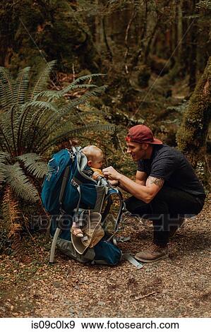 Stock Photo - Hiker with baby exploring forest, Queenstown, Canterbury, New Zealand. Fotosearch