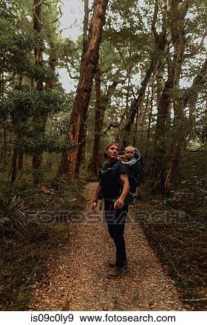 Stock Photo - Hiker with baby exploring forest, Queenstown, Canterbury, New Zealand. Fotosearch