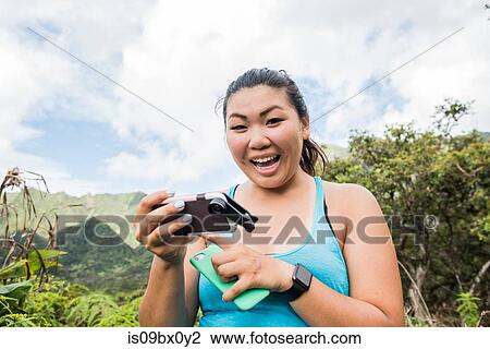 Hiker with cellphones in rainforest, Iao Valley, Maui, Hawaii View Large Photo Image Stock Image - Hiker with cellphones in rainforest, Iao Valley, Maui, Hawaii. Fotosearch
