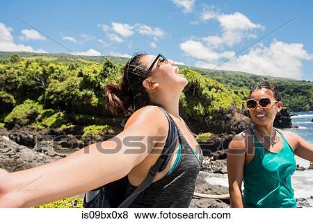 Stock Photo - Hikers enjoying sunshine on coast of Waipipi Trail, Maui, Hawaii. Fotosearch