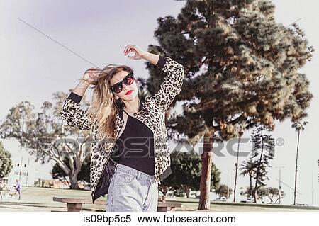 Stock Photography - Hip young woman dancing in park. Fotosearch