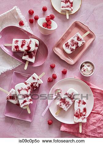 Ice lollies on pink plates and raspberries, pink background View Large Photo Image Picture - Ice lollies on pink plates and raspberries, pink background. Fotosearch