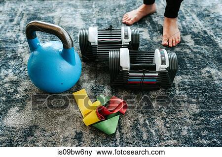 Kettle bell and assortment of exercise equipment by pair of feet View Large Photo Image Stock Photo - Kettle bell and assortment of exercise equipment by pair of feet. Fotosearch