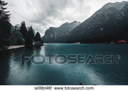 Landscape with lake and snow capped mountains, Dolomites, Italy View Large Photo Image Stock Image - Landscape with lake and snow capped mountains, Dolomites, Italy. Fotosearch