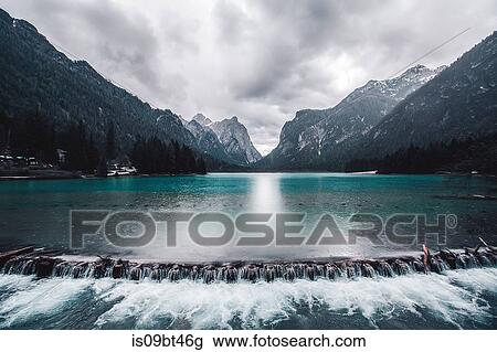 Landscape with lake weir and snow capped mountains, Dolomites, Italy View Large Photo Image Stock Image - Landscape with lake weir and snow capped mountains, Dolomites, Italy. Fotosearch