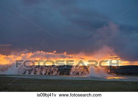 Landscape with steaming geysers at sunset, Yellowstone National Park, Wyoming, USA View Large Photo Image Stock Photo - Landscape with steaming geysers at sunset, Yellowstone National Park, Wyoming, USA. Fotosearch