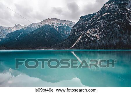 Landscape with turquoise lake and snow capped mountains, Dolomites, Italy View Large Photo Image Stock Image - Landscape with turquoise lake and snow capped mountains, Dolomites, Italy. Fotosearch