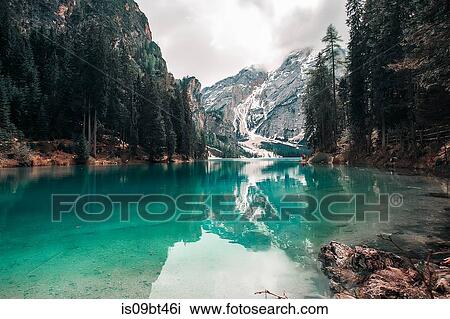 Landscape with turquoise lake and snow capped mountains, Dolomites, Italy View Large Photo Image Stock Image - Landscape with turquoise lake and snow capped mountains, Dolomites, Italy. Fotosearch