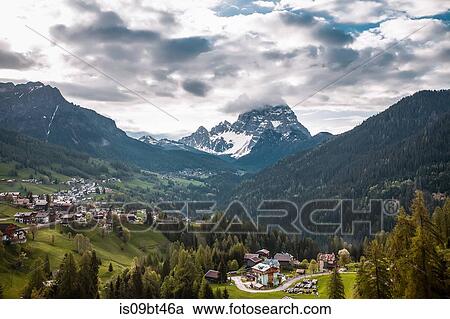 Landscape with valley villages and snow capped mountains, Dolomites, Italy View Large Photo Image Stock Image - Landscape with valley villages and snow capped mountains, Dolomites, Italy. Fotosearch