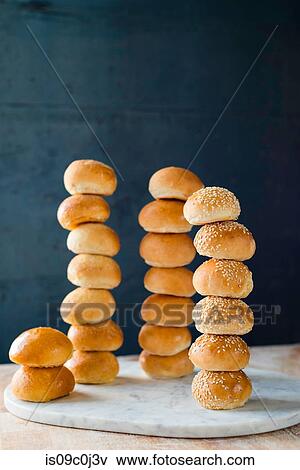 Large group of stacked white bread rolls on cutting board View Large Photo Image Stock Photo - Large group of stacked white bread rolls on cutting board. Fotosearch