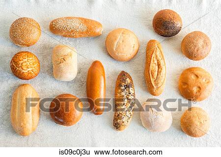 Large variety of wholemeal and white bread rolls, overhead view View Large Photo Image Stock Photograph - Large variety of wholemeal and white bread rolls, overhead view. Fotosearch