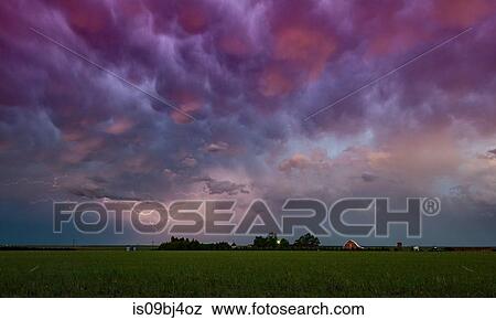 Stock Photo - Lightning under storm cloud over farmhouse, Wray, Colorado, US. Fotosearch