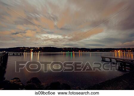 Stock Image - Lights across water on coastline, Bainbridge, Washington, United States. Fotosearch