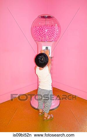 Little boy playing with gumball machine View Large Photo Image Picture - Little boy playing with gumball machine. Fotosearch