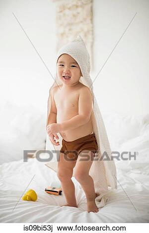 Little boy with hooded towel in bed View Large Photo Image Stock Image - Little boy with hooded towel in bed. Fotosearch