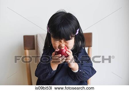 Little girl biting into apple View Large Photo Image Stock Image - Little girl biting into apple. Fotosearch
