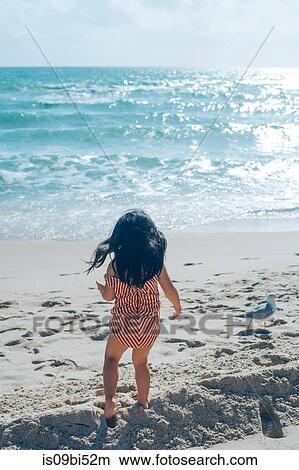 Little girl on beach View Large Photo Image Picture - Little girl on beach. Fotosearch