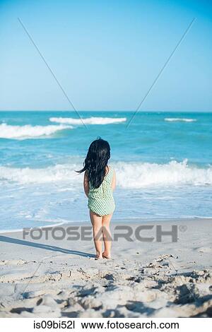 Stock Image - Little girl on beach. Fotosearch