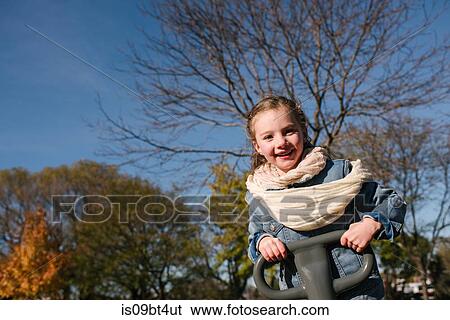 Little girl playing in park View Large Photo Image Stock Photograph - Little girl playing in park. Fotosearch