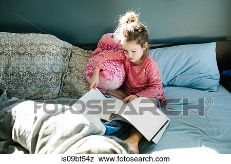 Little girl reading in bed View Large Photo Image Stock Photo - Little girl reading in bed. Fotosearch
