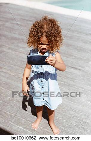 Little girl using smartphone on porch View Large Photo Image Stock Image - Little girl using smartphone on porch. Fotosearch