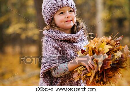 Little girl with handful of autumn leaves View Large Photo Image Stock Photography - Little girl with handful of autumn leaves. Fotosearch