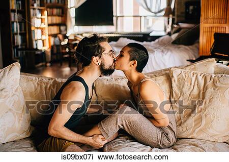 Loving couple relaxing on sofa View Large Photo Image Stock Image - Loving couple relaxing on sofa. Fotosearch