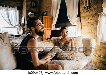 Loving couple relaxing on sofa View Large Photo Image Stock Image - Loving couple relaxing on sofa. Fotosearch