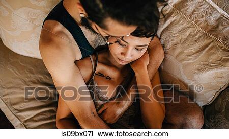 Stock Image - Loving couple relaxing on sofa. Fotosearch