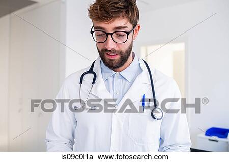 Male doctor at hospital reception View Large Photo Image Stock Image - Male doctor at hospital reception. Fotosearch