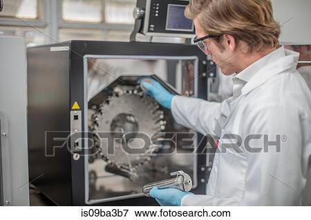 Stock Photo - Male worker in thread factory, using machinery. Fotosearch