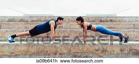 Man and woman exercising outdoors, doing push-ups on steps, South Point Park, Miami Beach, Florida, USA View Large Photo Image Stock Image - Man and woman exercising outdoors, doing push-ups on steps, South Point Park, Miami Beach, Florida, USA. Fotosearch