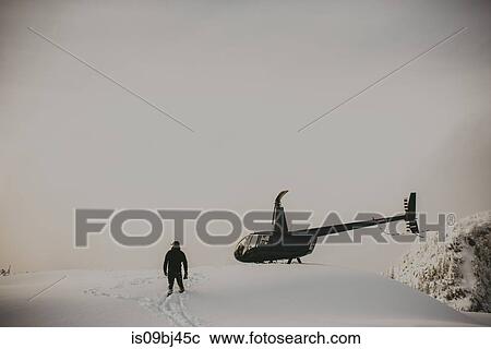 Man by helicopter in deep snow on mountain, Abbotsford, Canada View Large Photo Image Stock Image - Man by helicopter in deep snow on mountain, Abbotsford, Canada. Fotosearch