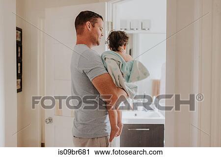 Man carrying daughter in bathroom View Large Photo Image Stock Image - Man carrying daughter in bathroom. Fotosearch