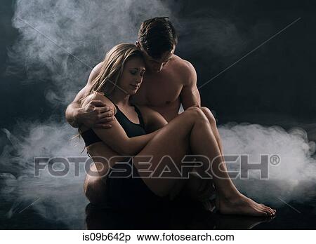 Man carrying woman against smoky background View Large Photo Image Stock Photography - Man carrying woman against smoky background. Fotosearch