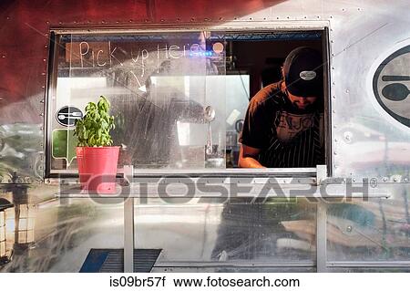 Man cooking in camper van food truck View Large Photo Image Stock Image - Man cooking in camper van food truck. Fotosearch